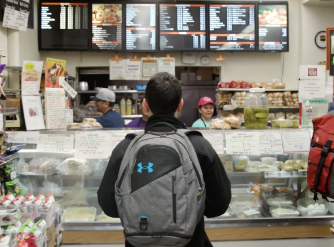 student looking at menu in the GW Deli