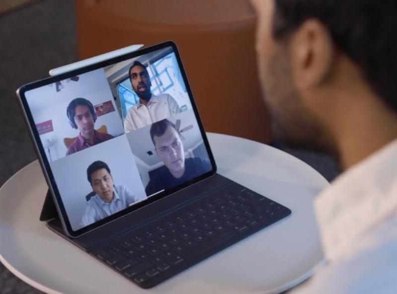 Student looking at zoom grid on tablet